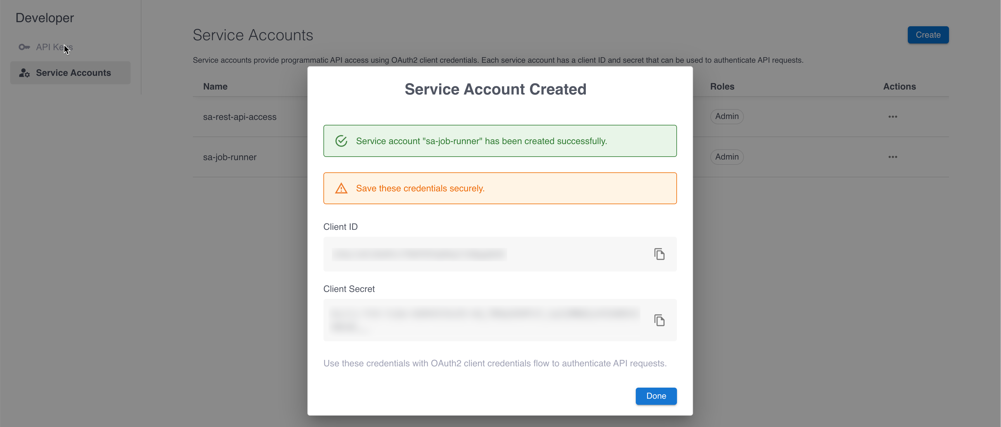 The service account created modal displaying credentials.